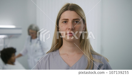 Adult nurse stands in hospital room with digital tablet computer Adult nurse stands in hospital room with digital tablet computer 107139255