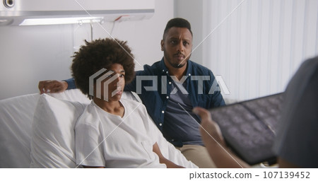 Doctor reports MRI scan results using tablet computer Doctor reports MRI scan results using tablet computer 107139452