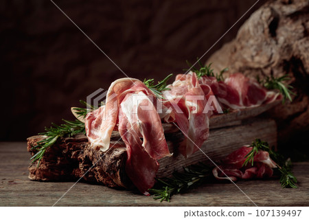Italian prosciutto crudo or Spanish jamon with rosemary. 107139497