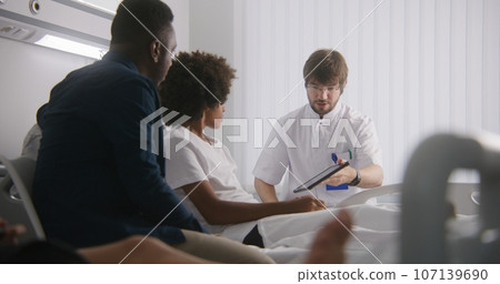 Doctor reports test results using tablet computer 107139690