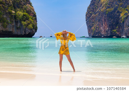 Beautiful young blonde woman in orange dress on... - Stock Photo  [107140384] - PIXTA