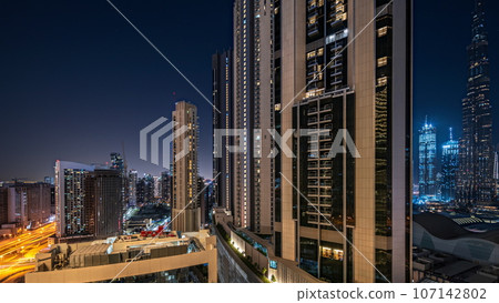 Tallest skyscrapers in downtown dubai located on bouleward street near shopping mall aerial night. 107142802