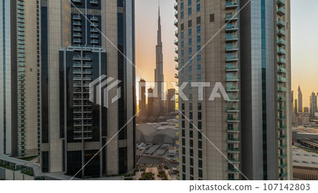 Tallest skyscrapers in downtown dubai located on bouleward street near shopping mall aerial all day. 107142803