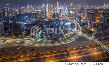 Panorama showing skyline of Dubai with business bay and downtown district night. Panorama showing skyline of Dubai with business bay and downtown district night. 107142896