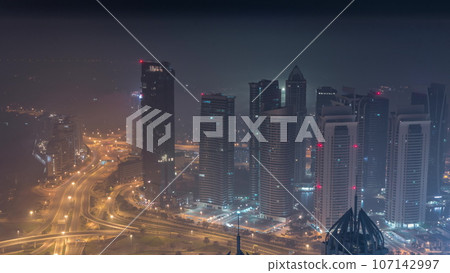 JLT and Dubai marina skyscrapers near Sheikh Zayed Road aerial all night. Residential buildings JLT and Dubai marina skyscrapers near Sheikh Zayed Road aerial all night. Residential buildings 107142997