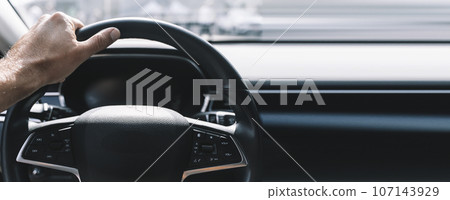 Driver car in car interior banner background. Driving on road. Hands on the steering wheel background 107143929