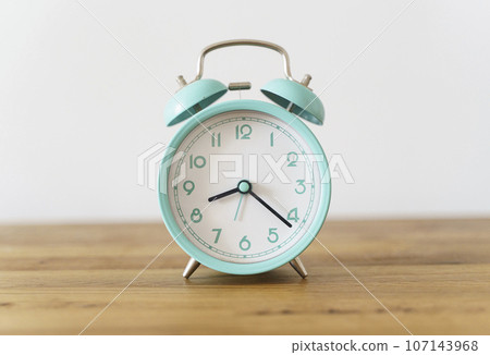 Alarm clock on the table background. Morning time and beginning of the day, timing, deadline concept Alarm clock on the table background. Morning time and beginning of the day, timing, deadline concept 107143968
