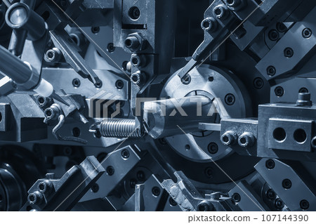 Close up the coil spring machine in light blue scene. Close up the coil spring machine in light blue scene. 107144390