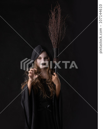 Girl in halloween witch costume Girl in halloween witch costume 107144610