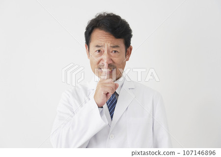 Middle-aged doctor posing in a secret pose, white background Middle-aged doctor posing in a secret pose, white background 107146896