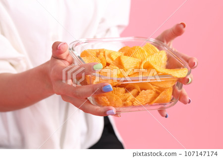 Hand with Potato Chips Hand with Potato Chips 107147174