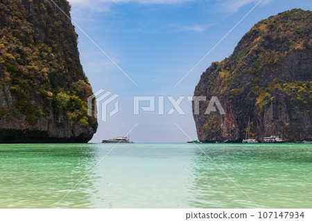 The legendary Maya Bay beach without people where the film "beach" with Leonardo DiCaprio was filmed with a beautiful bay of sand and clear turquoise water. UNESCO World Heritage. The legendary Maya Bay beach without people where the film "beach" with Leonardo DiCaprio was filmed with a beautiful bay of sand and clear turquoise water. UNESCO World Heritage. 107147934