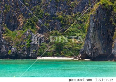 The legendary Maya Bay beach without people where the film "beach" with Leonardo DiCaprio was filmed with a beautiful bay of sand and clear turquoise water. UNESCO World Heritage. The legendary Maya Bay beach without people where the film "beach" with Leonardo DiCaprio was filmed with a beautiful bay of sand and clear turquoise water. UNESCO World Heritage. 107147946