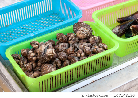 Basket with brown shelled sea urchins on a market stall in thailand. 107148136