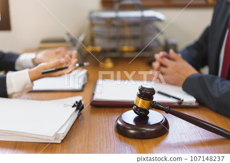 Legal and justice concept, Young female lawyer explains and consulting contract with senior lawyer Legal and justice concept, Young female lawyer explains and consulting contract with senior lawyer 107148237