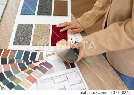 Architectural concept, Female architect choosing color on color swatch for house interior design 107148242
