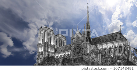 Notre Dame de Paris (against the background of sky with clouds), also known as Notre Dame Cathedral or simply Notre Dame, is a Gothic, Roman Catholic cathedral of Paris, France 107148491