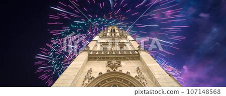 Celebratory fireworks over the Great gothic church of Saint Germain l Auxerrois, Paris, France 107148568