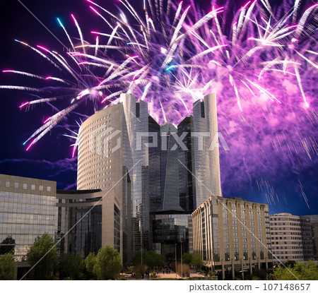 Celebratory fireworks over the Skyscrapers La Defense, commercial and business center of Paris, France 107148657
