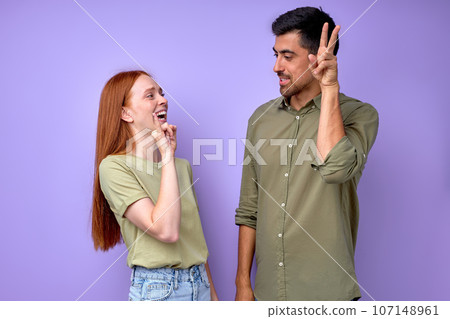 Young cheerful happy deaf mute couple using sign language Young cheerful happy deaf mute couple using sign language 107148961