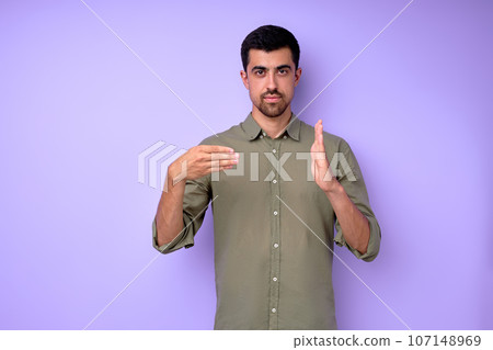 Young serious bearded deaf mute man showing number 400 Young serious bearded deaf mute man showing number 400 107148969