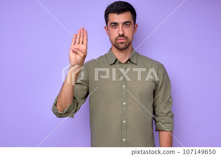 closeup portrait of serious man showing hello hi sign in deaf language closeup portrait of serious man showing hello hi sign in deaf language 107149650