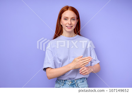 pleasant smiling redhead girl explaining something with hands pleasant smiling redhead girl explaining something with hands 107149652
