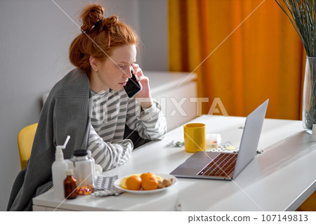 pale unhealthy redhead woman wrapped in blanket talking with friend pale unhealthy redhead woman wrapped in blanket talking with friend 107149813