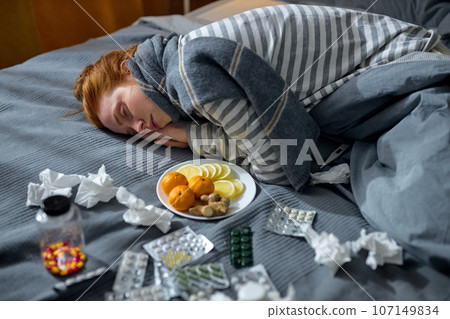 tired exhausted pale girl lying on bed tired exhausted pale girl lying on bed 107149834