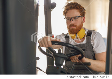 Professional forklift driver in working in wood warehouse and loading wooden board Professional forklift driver in working in wood warehouse and loading wooden board 107150516
