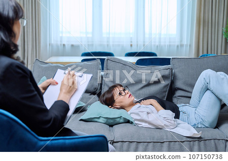 Middle aged frustrated sad woman in psychological therapy session Middle aged frustrated sad woman in psychological therapy session 107150738