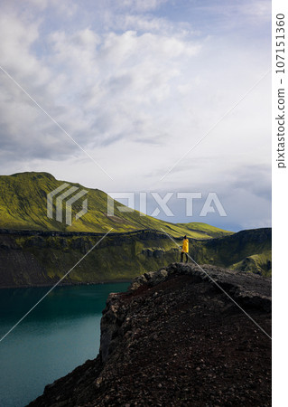 Backpacker girl contemplating the beauty of Blahylur lake in Iceland Backpacker girl contemplating the beauty of Blahylur lake in Iceland 107151360