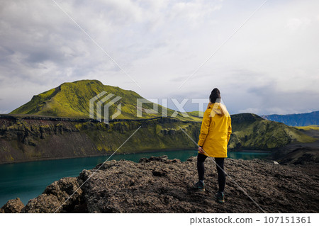 Backpacker girl admiring Blahylur lake in Iceland Backpacker girl admiring Blahylur lake in Iceland 107151361