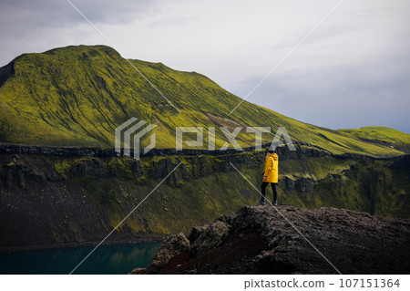 Backpacker girl takes in the view of Blahylur lake in Iceland Backpacker girl takes in the view of Blahylur lake in Iceland 107151364