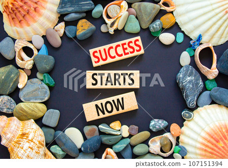 Success starts now symbol. Concept word Success starts now on beautiful wooden block. Sea shell stone. Beautiful black table background. Business motivational success starts now concept. Copy space. Success starts now symbol. Concept word Success starts now on beautiful wooden block. Sea shell stone. Beautiful black table background. Business motivational success starts now concept. Copy space. 107151394