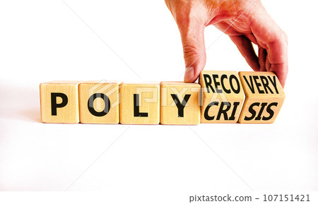 Polycrisis or polyrecovery symbol. Concept words Polycrisis Polyrecovery on wooden cubes. Beautiful white background. Businessman hand. Business Polycrisis or polyrecovery concept. Copy space. 107151421
