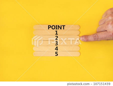 Time to point 2 symbol. Concept word Point 1 2 3 4 5 on wooden sticks. Businessman hand. Beautiful yellow table yellow background. Business planning and time to point 2 concept. Copy space. 107151439