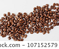 A minimalistic scene: coffee beans on a pristine white surface. 107152579