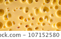 Hard Dutch cheese with holes. Background texture from products. 107152580