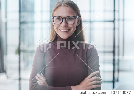 Front portrait of pretty young woman in office 107153077