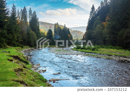 mountainous countryside scenery with river. carpathinan nature landscape in fall season 107153212