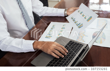 Businessmen bookkeeper hand use laptop analysis the graph for Setting challenging business goals and ready to achieve target at home office 107153281
