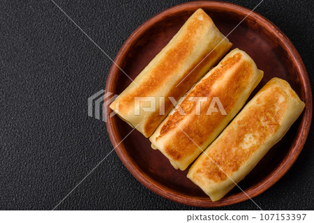 Delicious fresh homemade fried pancakes with broccoli and meat or fish Delicious fresh homemade fried pancakes with broccoli and meat or fish 107153397