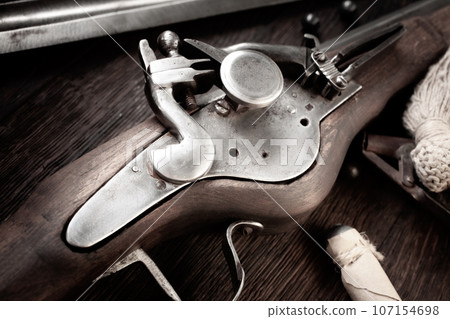 17th century ancient flintlock musket with powder flask and led bullets. 17th century ancient flintlock musket with powder flask and led bullets. 107154698