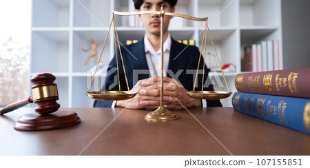 Portrait of a judge hold judges gavel and old scales concept of justice lawyer concept Judge 107155851