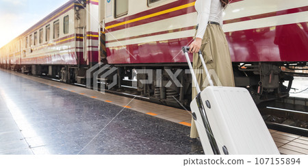 Travel concept at train station, Young Tour woman asian walking dragging luggage suitcase bag. Asian women waiting for train and planning happy holiday vacation Travel concept at train station, Young Tour woman asian walking dragging luggage suitcase bag. Asian women waiting for train and planning happy holiday vacation 107155894