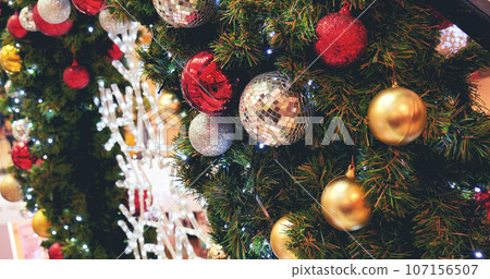 Colourful glittering baubles ornament ball decorated christmas tree on holiday winter xmas happy new year festival celebration. Red, gold, silver ball on Christmas tree. Merry Christmas happy new year Colourful glittering baubles ornament ball decorated christmas tree on holiday winter xmas happy new year festival celebration. Red, gold, silver ball on Christmas tree. Merry Christmas happy new year 107156507