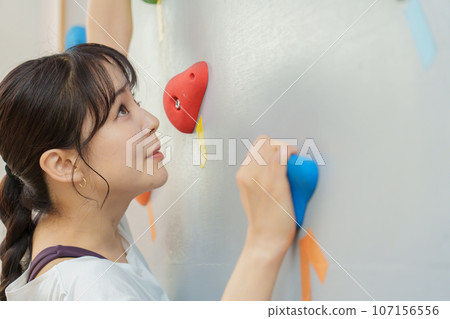 Young woman bouldering 107156556