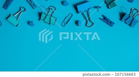 Monochromatic Frame border made of school stationery supplies. Copy space for your text or Educational greeting announcement for students and teacher. Creative vivid blue background. Concept of new 107156663