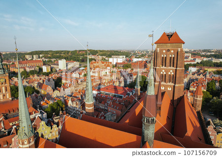 St. Mary's Basilica Beautiful panoramic architecture of old town in Gdansk, Poland at sunrise. Aerial view drone pov. Landscape cityscape City from Above. Small vintage historical buildings Europe St. Mary's Basilica Beautiful panoramic architecture of old town in Gdansk, Poland at sunrise. Aerial view drone pov. Landscape cityscape City from Above. Small vintage historical buildings Europe 107156709